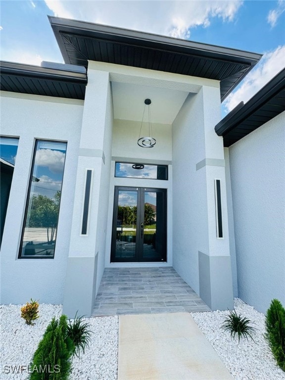 doorway to property with french doors and stucco siding