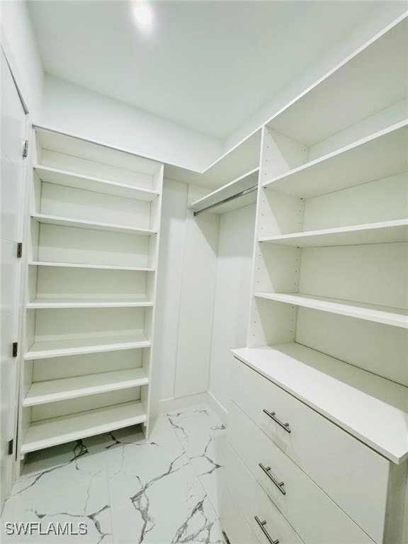 spacious closet with marble finish floor