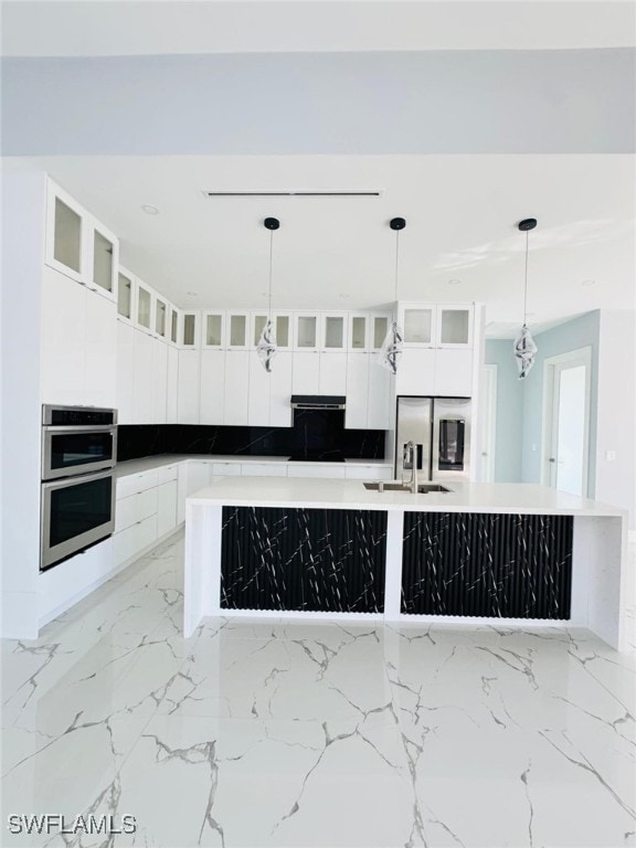 kitchen featuring stainless steel appliances, marble finish floor, white cabinetry, and a spacious island