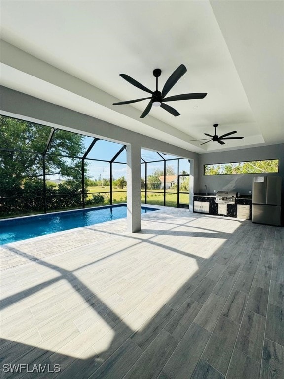 unfurnished sunroom with a raised ceiling and a swimming pool