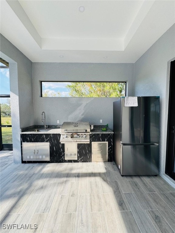 view of patio / terrace featuring a grill, a sink, and area for grilling