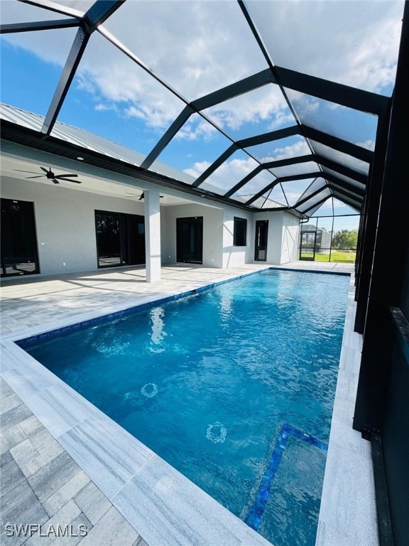 pool with a patio area, a lanai, and a ceiling fan