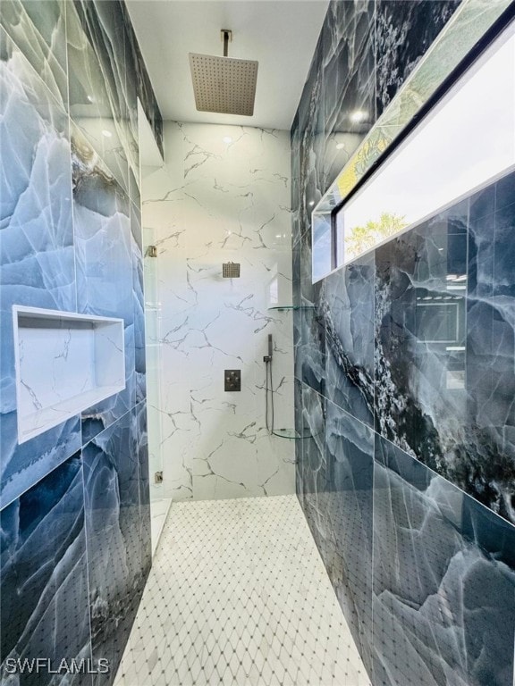 bathroom with a marble finish shower