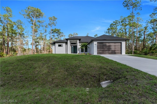 view of front of house with driveway, a garage, and a front yard