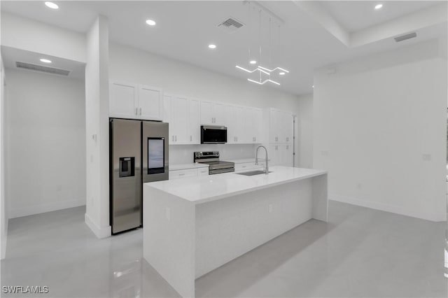 kitchen with white cabinetry, visible vents, stainless steel appliances, and a sink