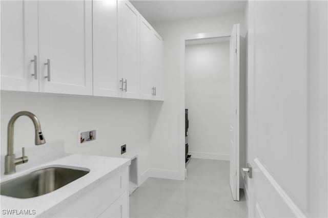 clothes washing area featuring washer hookup, a sink, baseboards, cabinet space, and electric dryer hookup