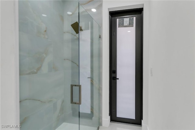 bathroom with a marble finish shower