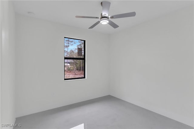 spare room featuring concrete flooring and a ceiling fan