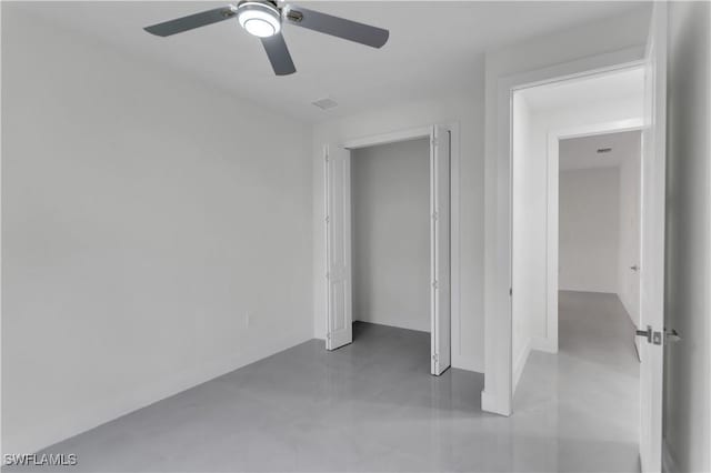 unfurnished bedroom with ceiling fan, concrete floors, and visible vents