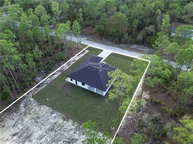 drone / aerial view featuring a forest view