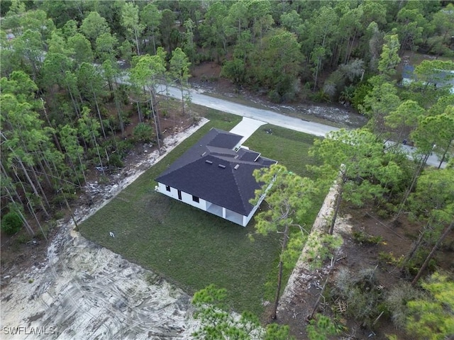 drone / aerial view featuring a view of trees