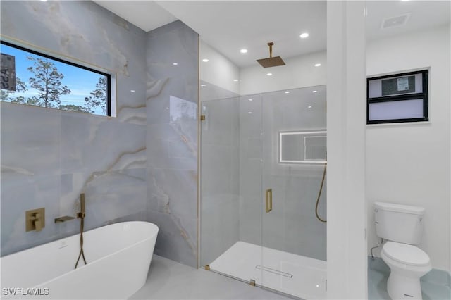 bathroom with tile walls, a soaking tub, visible vents, toilet, and a shower stall