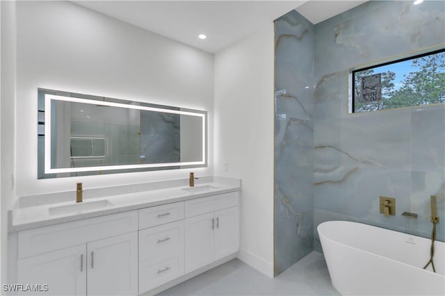 full bathroom featuring recessed lighting, a soaking tub, a sink, and double vanity