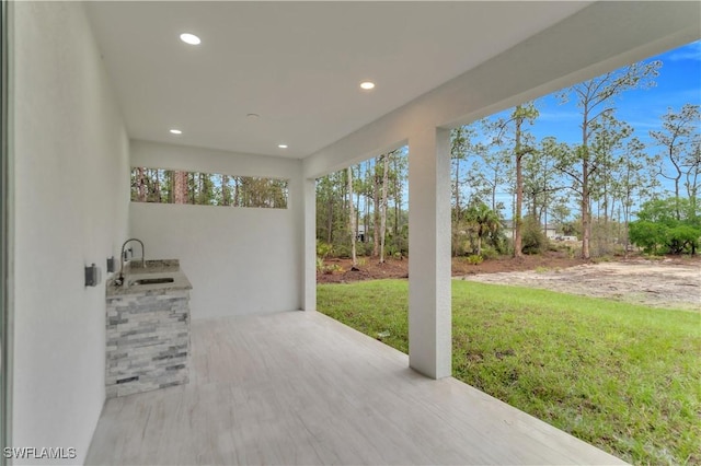 view of patio / terrace featuring exterior kitchen and a sink