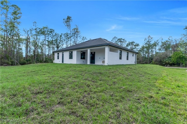 ranch-style house with a front lawn and stucco siding