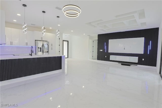 kitchen with recessed lighting, white cabinetry, marble finish floor, stainless steel fridge with ice dispenser, and decorative light fixtures