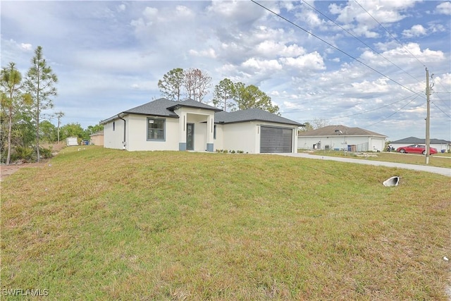 prairie-style home with a garage, concrete driveway, a front lawn, and stucco siding