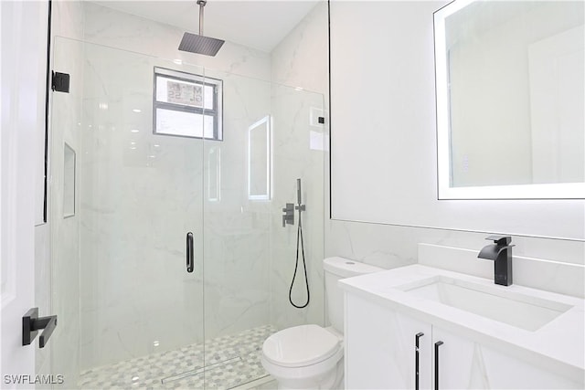 full bath with toilet, a marble finish shower, tile walls, and vanity