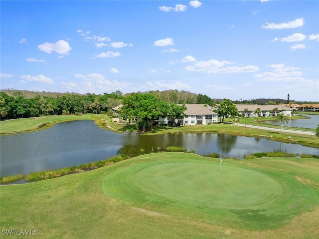 view of property's community featuring a lawn and a water view