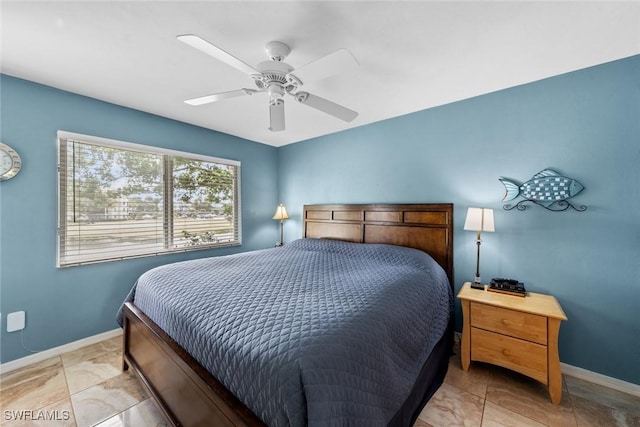 bedroom featuring a ceiling fan and baseboards