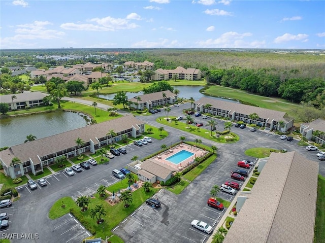 aerial view featuring golf course view and a water view