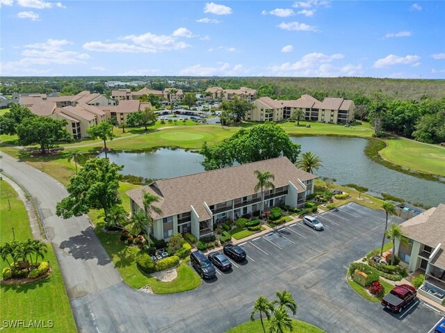 aerial view featuring golf course view, a water view, and a residential view