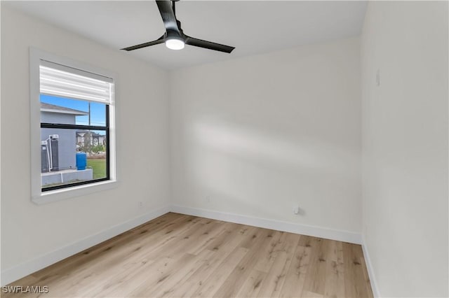 spare room with light wood-style flooring, baseboards, and ceiling fan