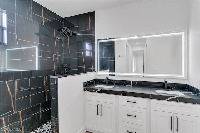 full bath featuring double vanity, walk in shower, and a sink