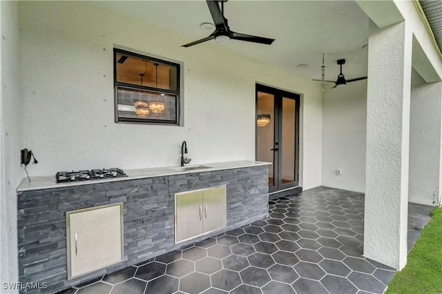 view of patio / terrace featuring ceiling fan and an outdoor kitchen