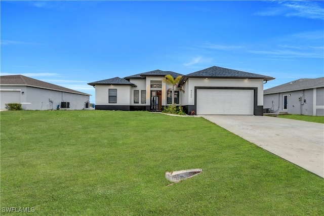 prairie-style home featuring central AC unit, an attached garage, driveway, stucco siding, and a front lawn