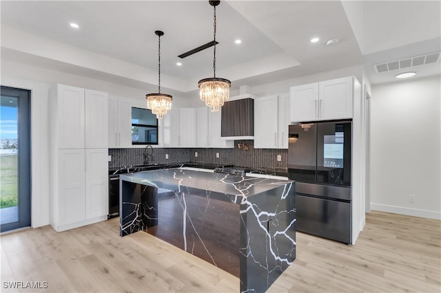 kitchen featuring smart refrigerator, visible vents, a raised ceiling, and decorative backsplash