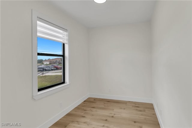 empty room featuring light wood-style flooring and baseboards