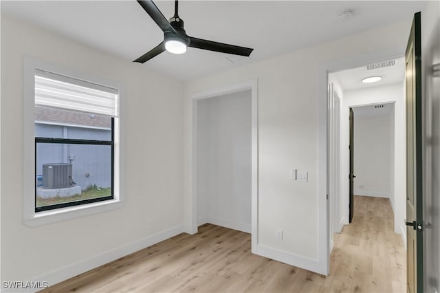 unfurnished bedroom with light wood-type flooring, visible vents, and baseboards