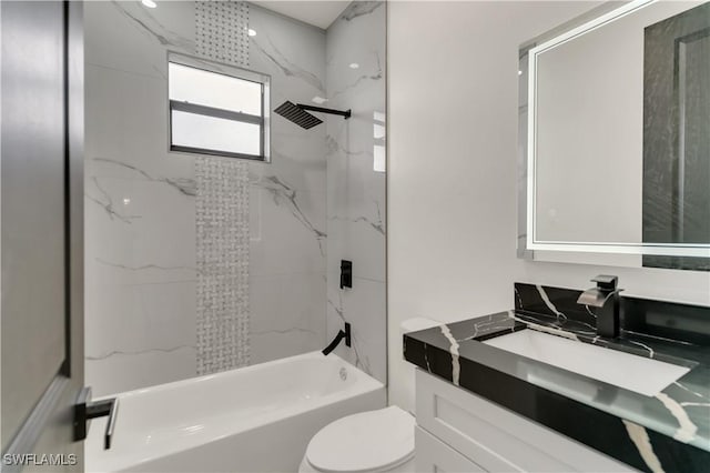 bathroom featuring toilet, bathing tub / shower combination, and vanity