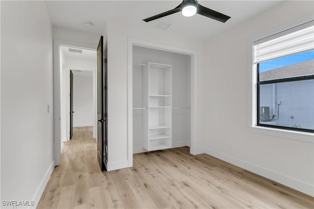 unfurnished bedroom featuring visible vents, light wood-style flooring, and baseboards