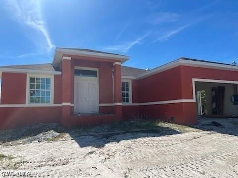 view of front facade featuring an attached garage and stucco siding