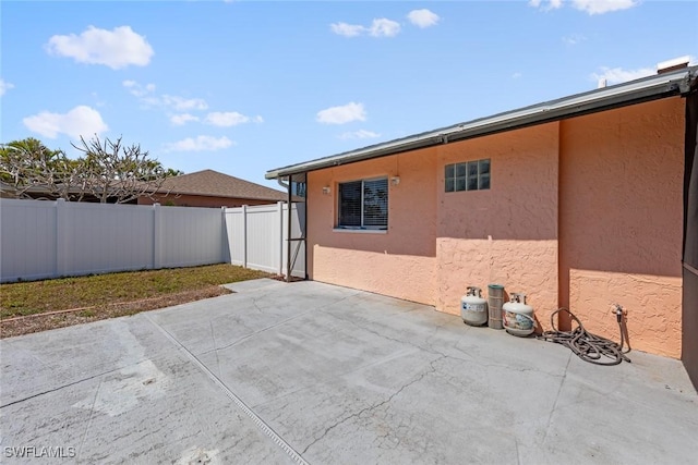 exterior space featuring stucco siding, a patio, and a fenced backyard