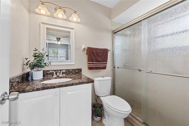 full bathroom featuring vanity, toilet, and a stall shower