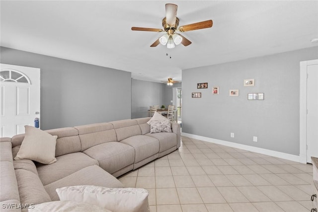 living room with light tile patterned floors, baseboards, and a ceiling fan