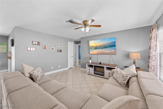 tiled living room with visible vents, baseboards, and ceiling fan