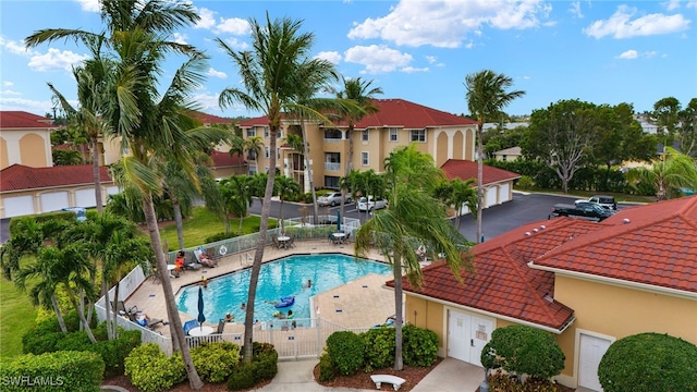 pool featuring a residential view, fence, and a patio