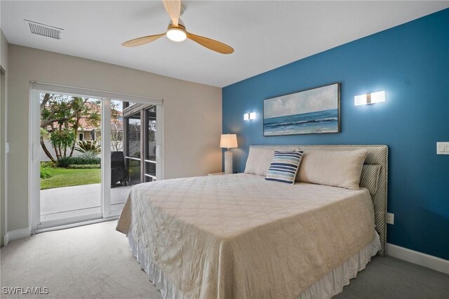 carpeted bedroom featuring access to exterior, baseboards, visible vents, and a ceiling fan