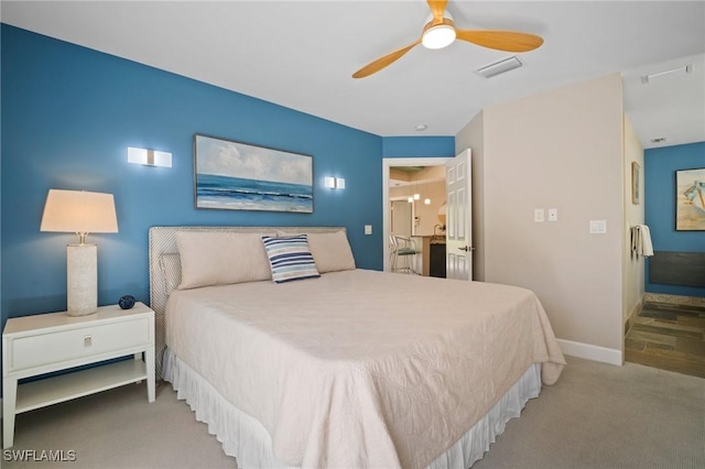 carpeted bedroom featuring a ceiling fan, visible vents, and baseboards