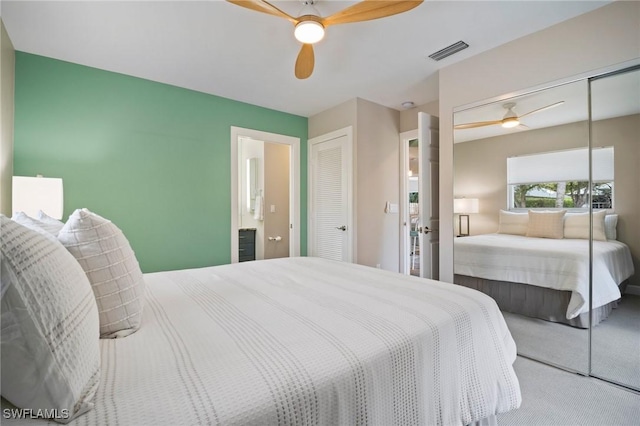 carpeted bedroom featuring a ceiling fan and visible vents