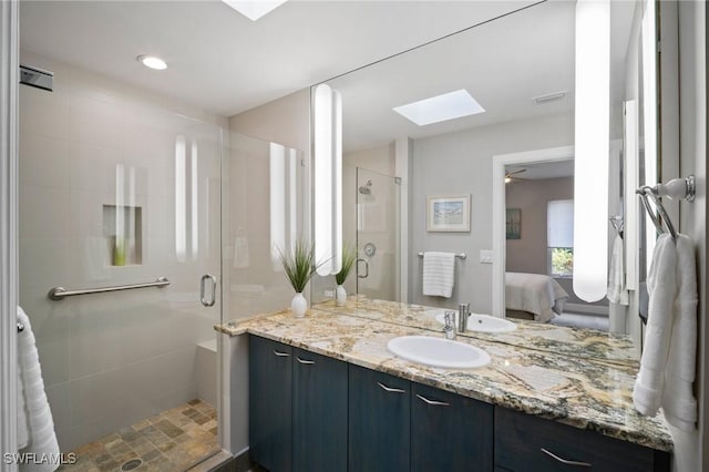 full bath featuring a skylight, visible vents, connected bathroom, vanity, and a shower stall