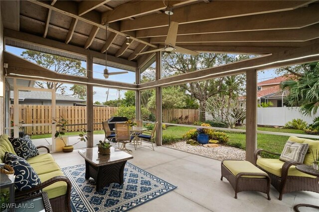 sunroom / solarium featuring vaulted ceiling and a ceiling fan