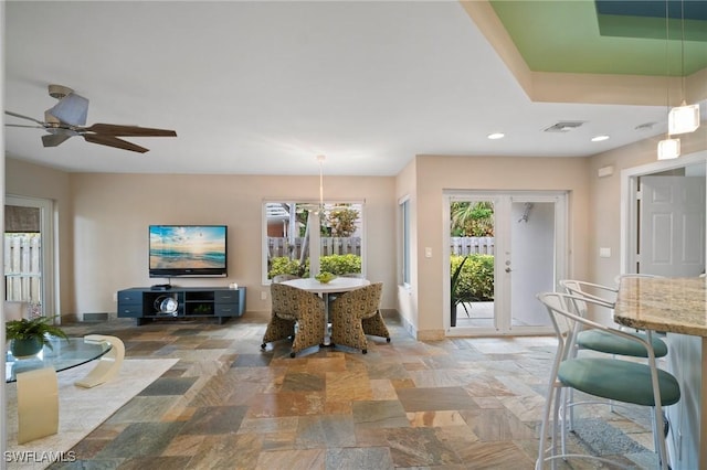 interior space with recessed lighting, a ceiling fan, visible vents, baseboards, and stone finish floor