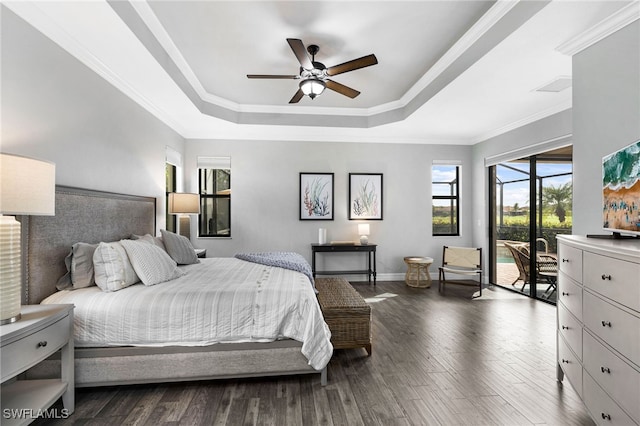 bedroom with access to exterior, a raised ceiling, ornamental molding, and wood finished floors