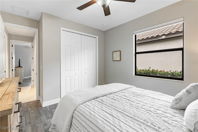 bedroom with a closet, ceiling fan, baseboards, and wood finished floors