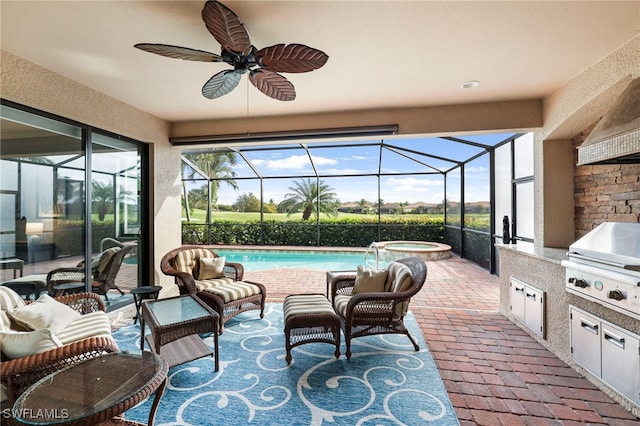 view of patio / terrace featuring a lanai, an outdoor kitchen, a ceiling fan, and area for grilling